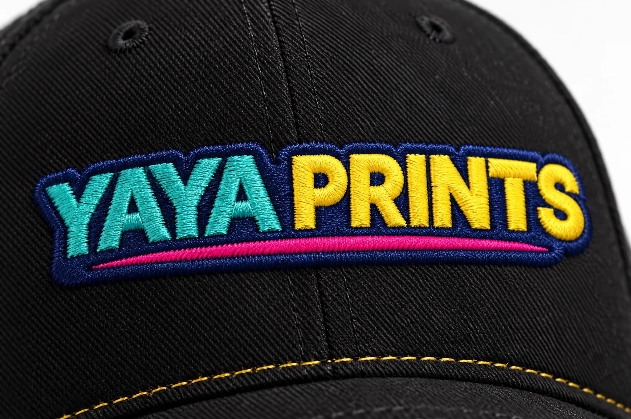 Close-up of the YAYA Prints logo embroidered on a black cap