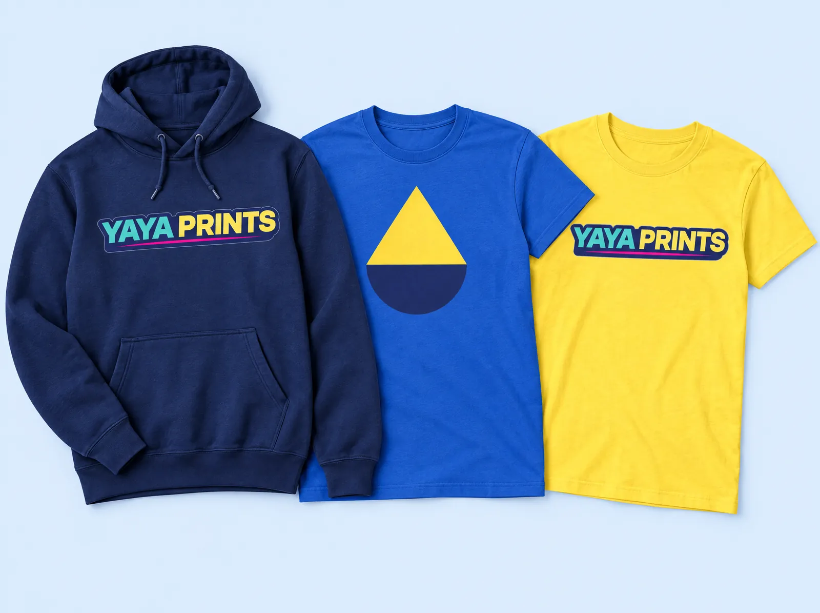A navy hoodie, a royal blue tee and a yellow tee printed with the YAYA Prints logo