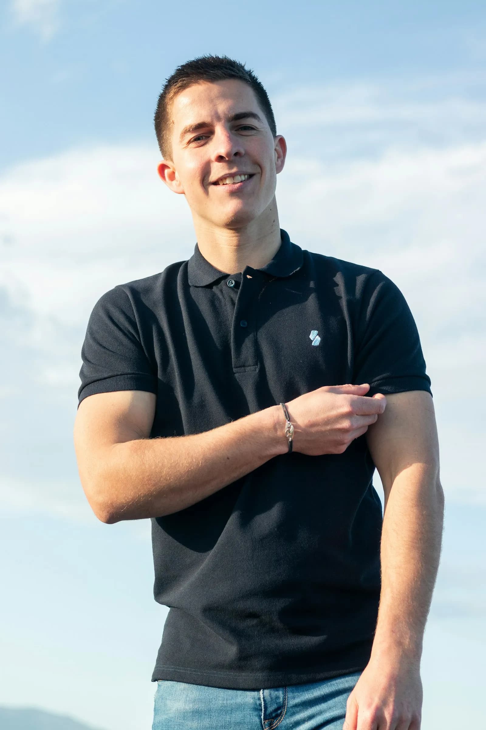 A worker wearing a branded company work polo
