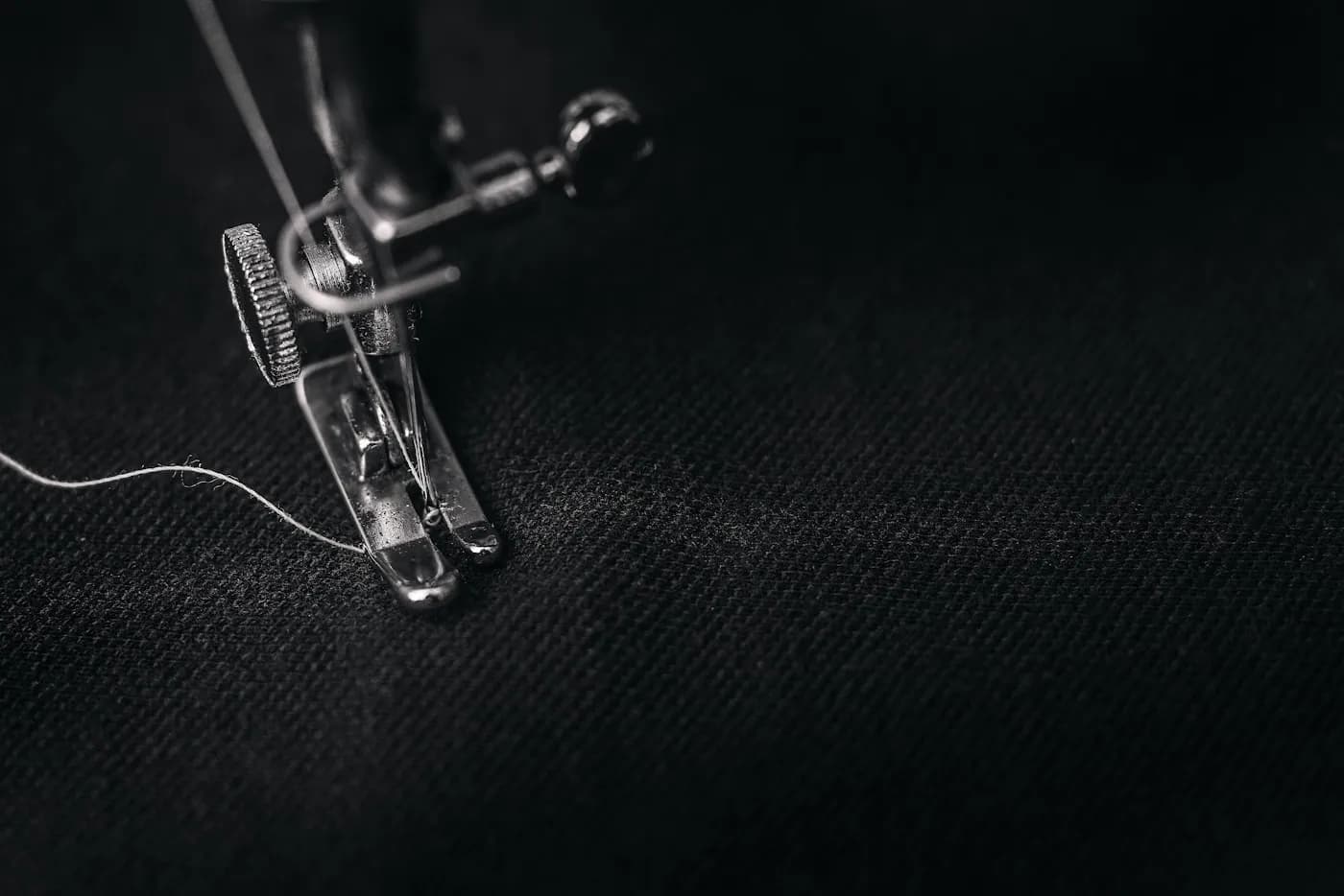 Close-up of an embroidered company logo stitched onto workwear