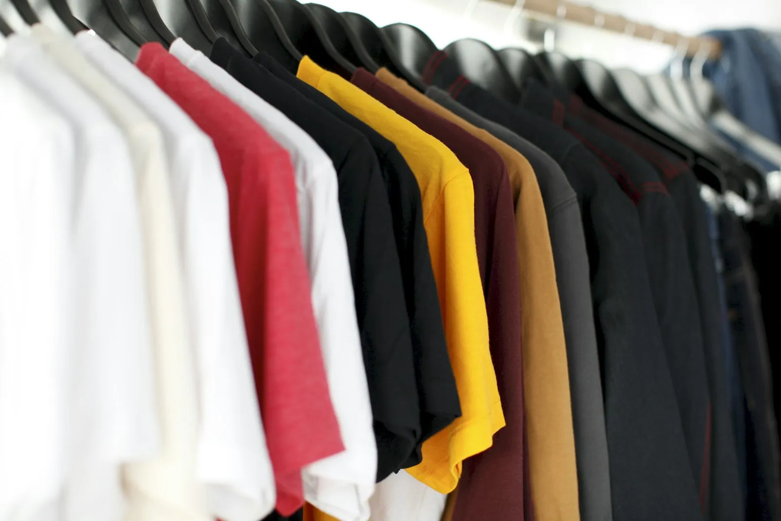 A rack of custom-printed apparel including long-sleeve shirts