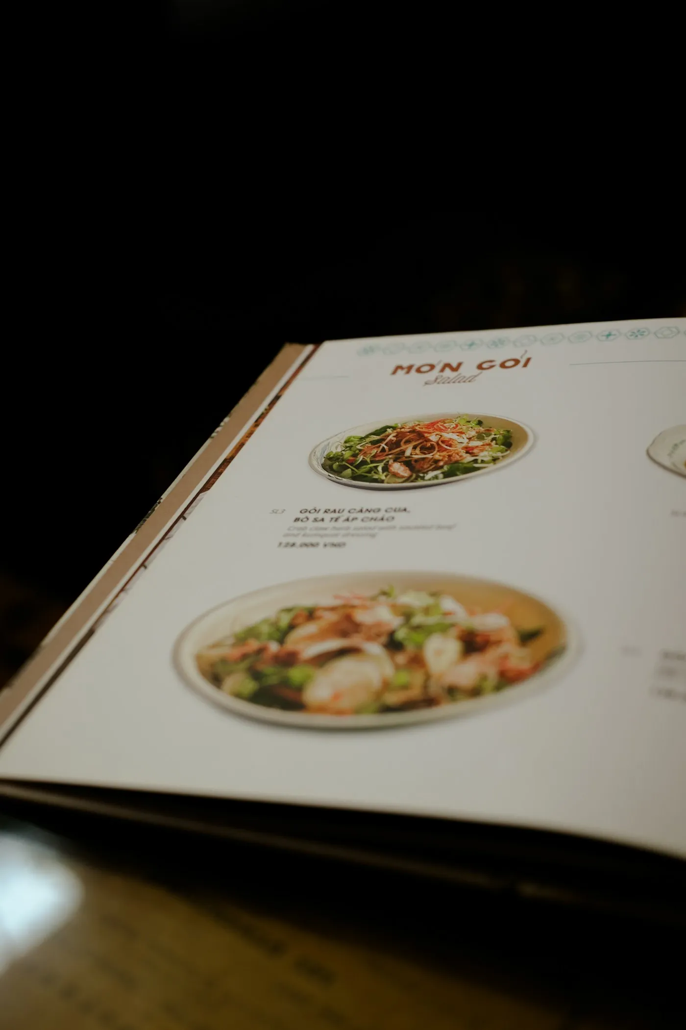 A printed restaurant menu open on a wooden table