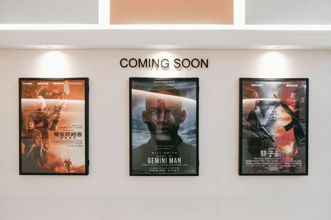 Framed printed posters displayed on a wall