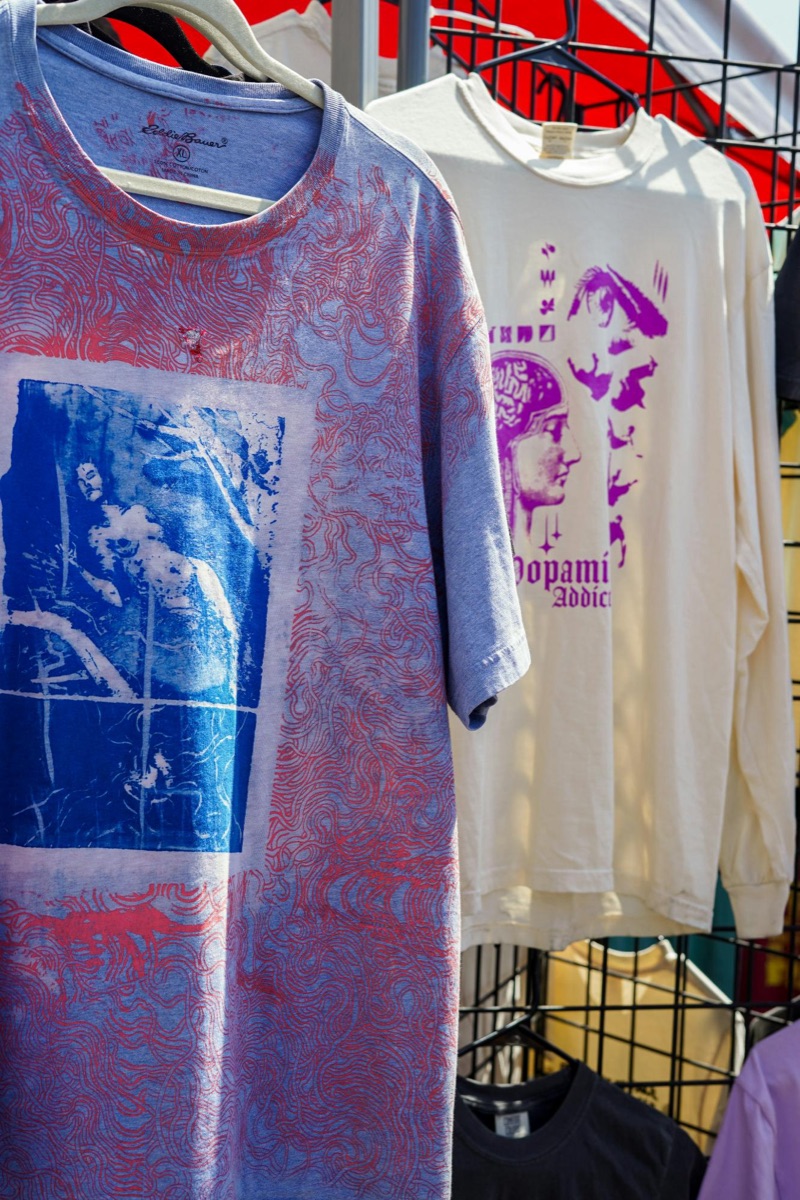 Custom t-shirt brand being managed on a laptop and phone