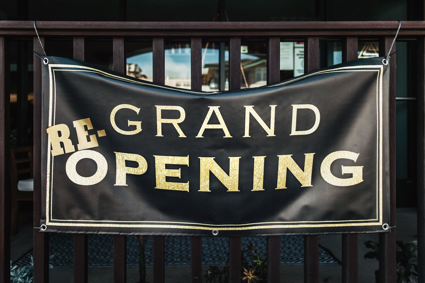 A printed vinyl banner strung up outside a shop