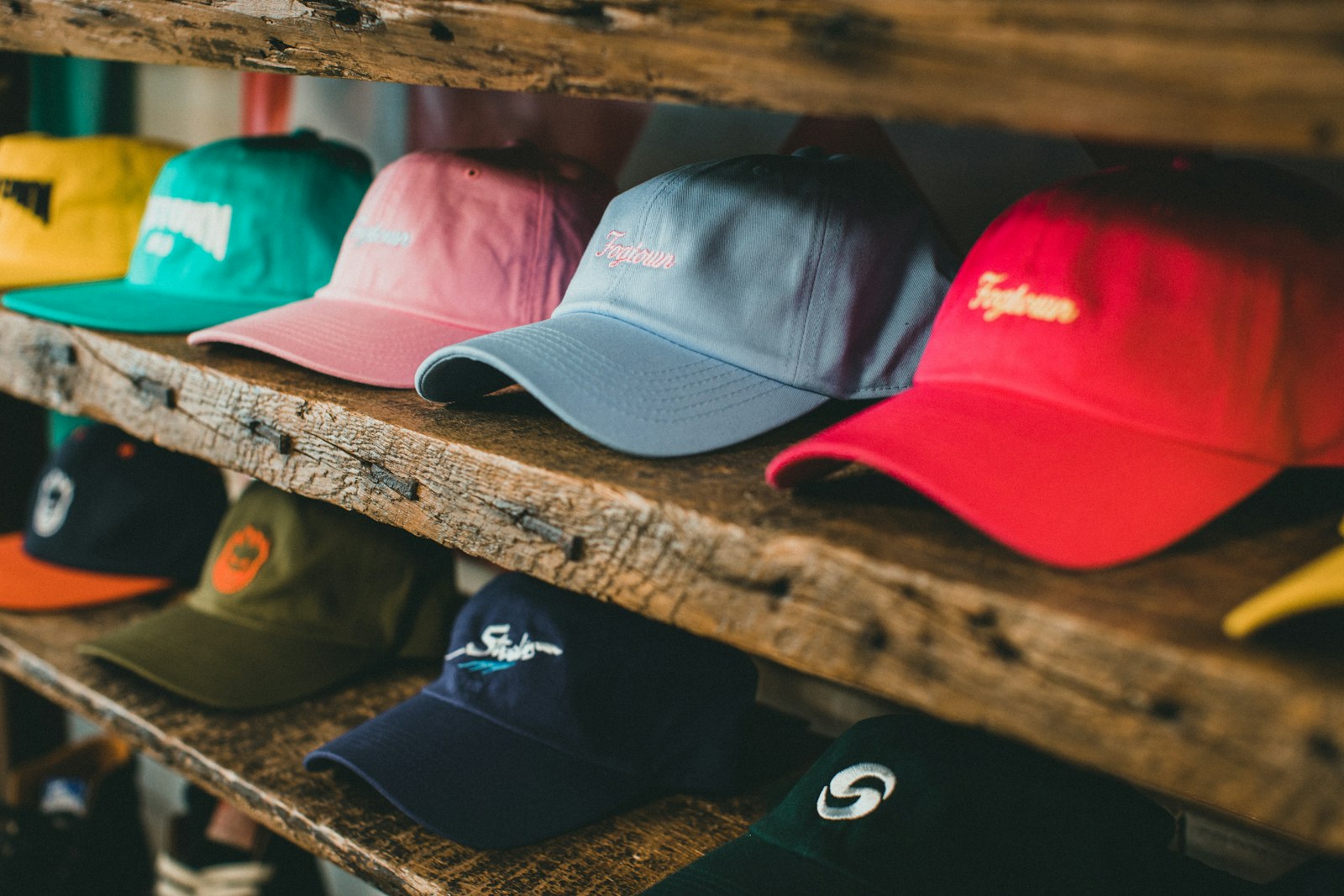 A rack of custom embroidered caps in several colours