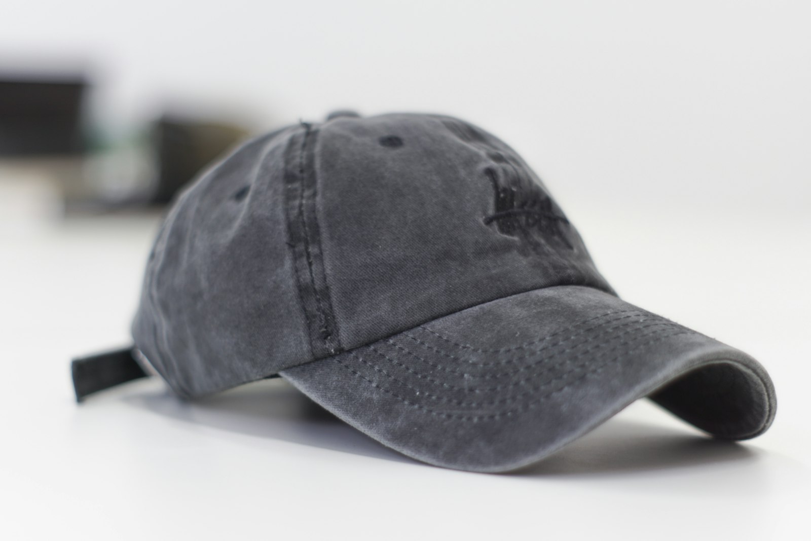 A washed grey six-panel baseball cap photographed flat against a white background