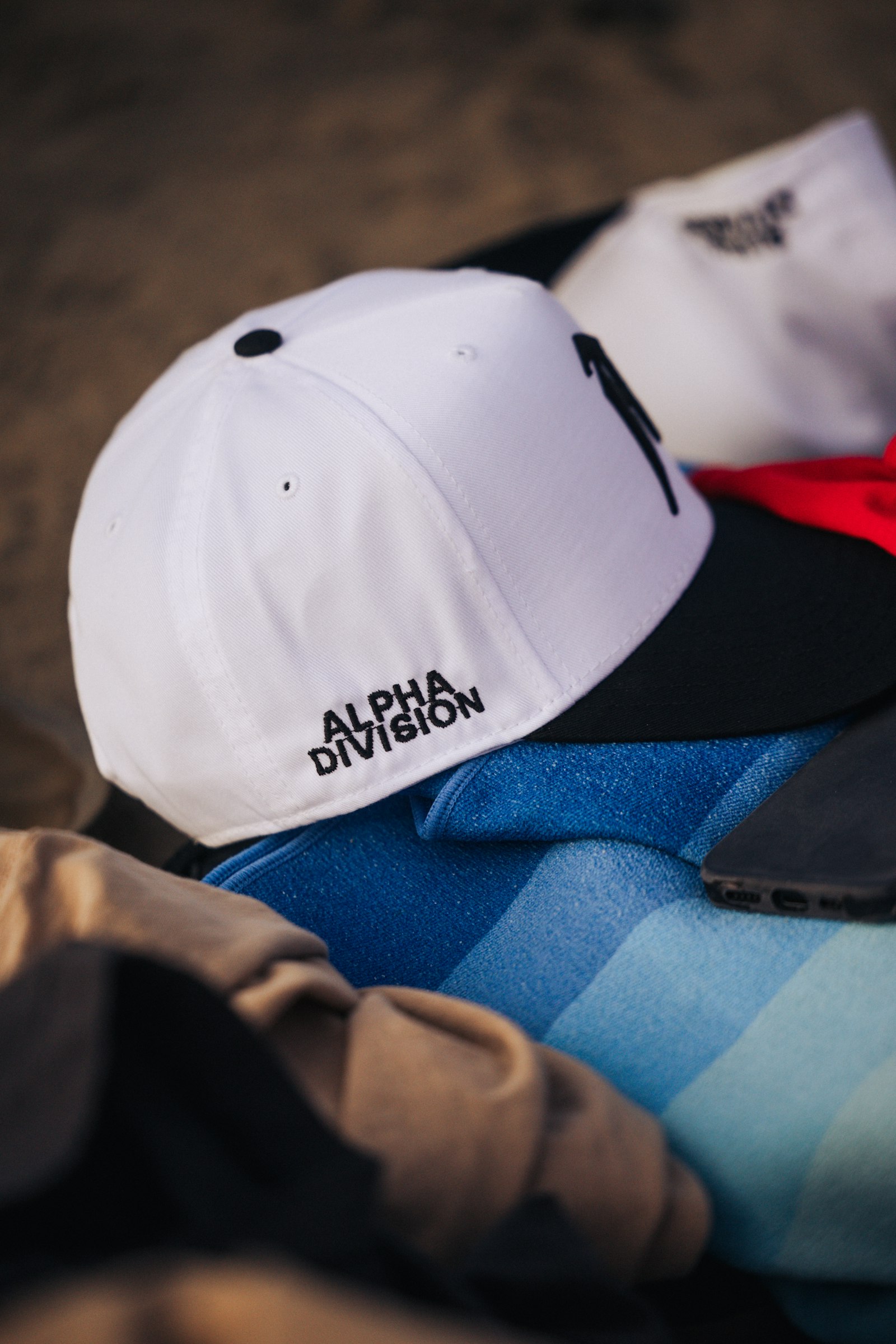 A white and navy two-tone cap with a small embroidered logo being worn