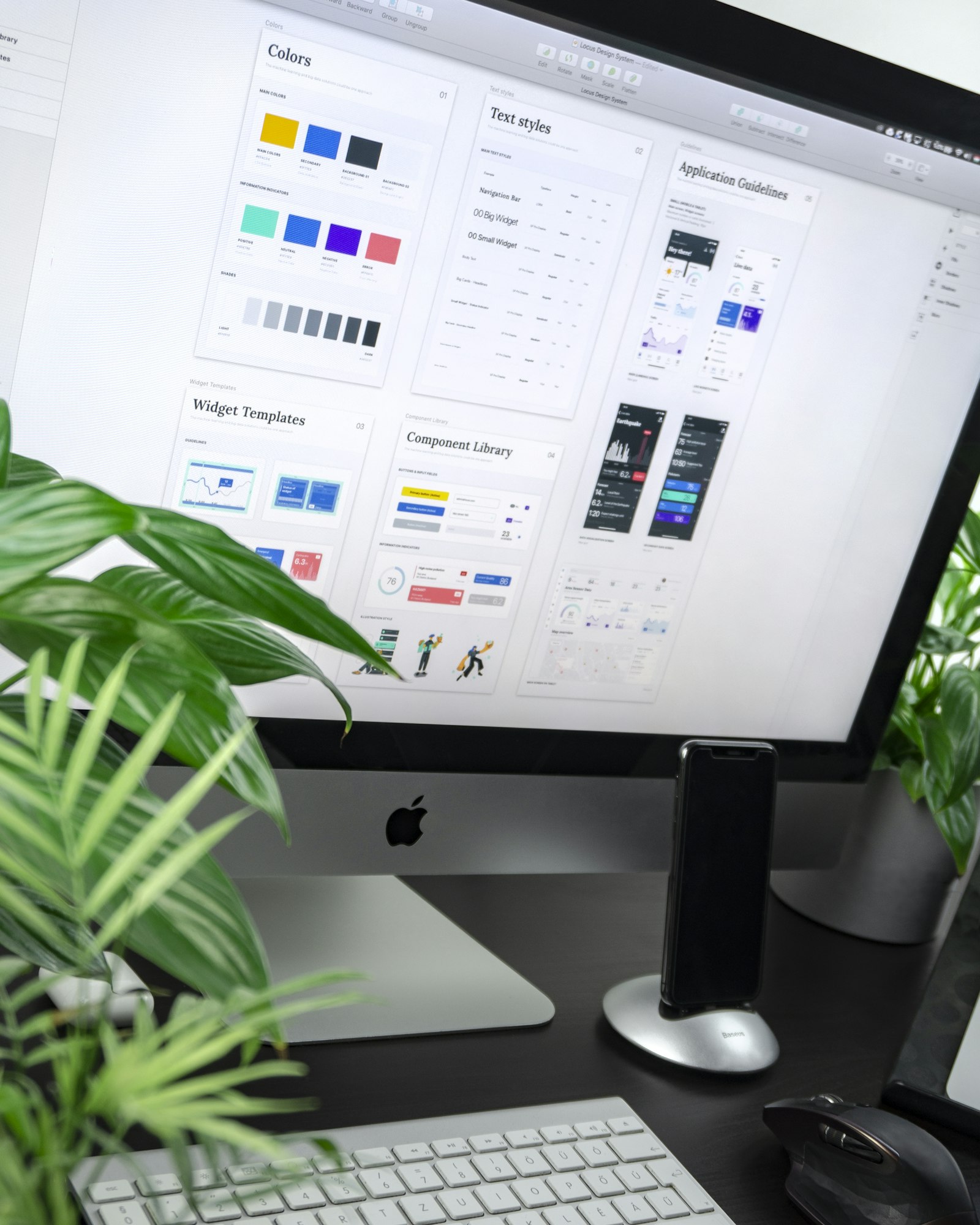 A laptop screen showing an online t-shirt design tool with a logo positioned on the chest of a garment preview