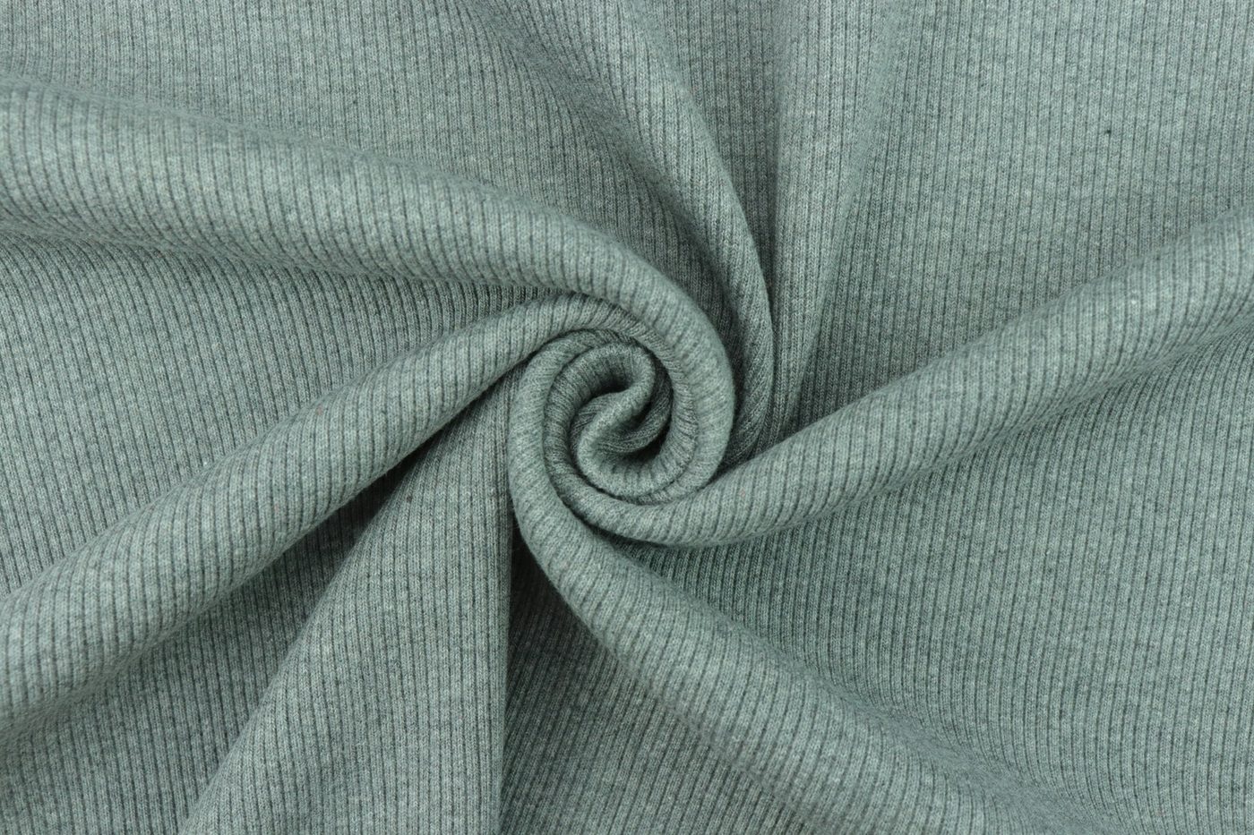 Close-up of sage-green ribbed knit fabric twisted into a spiral