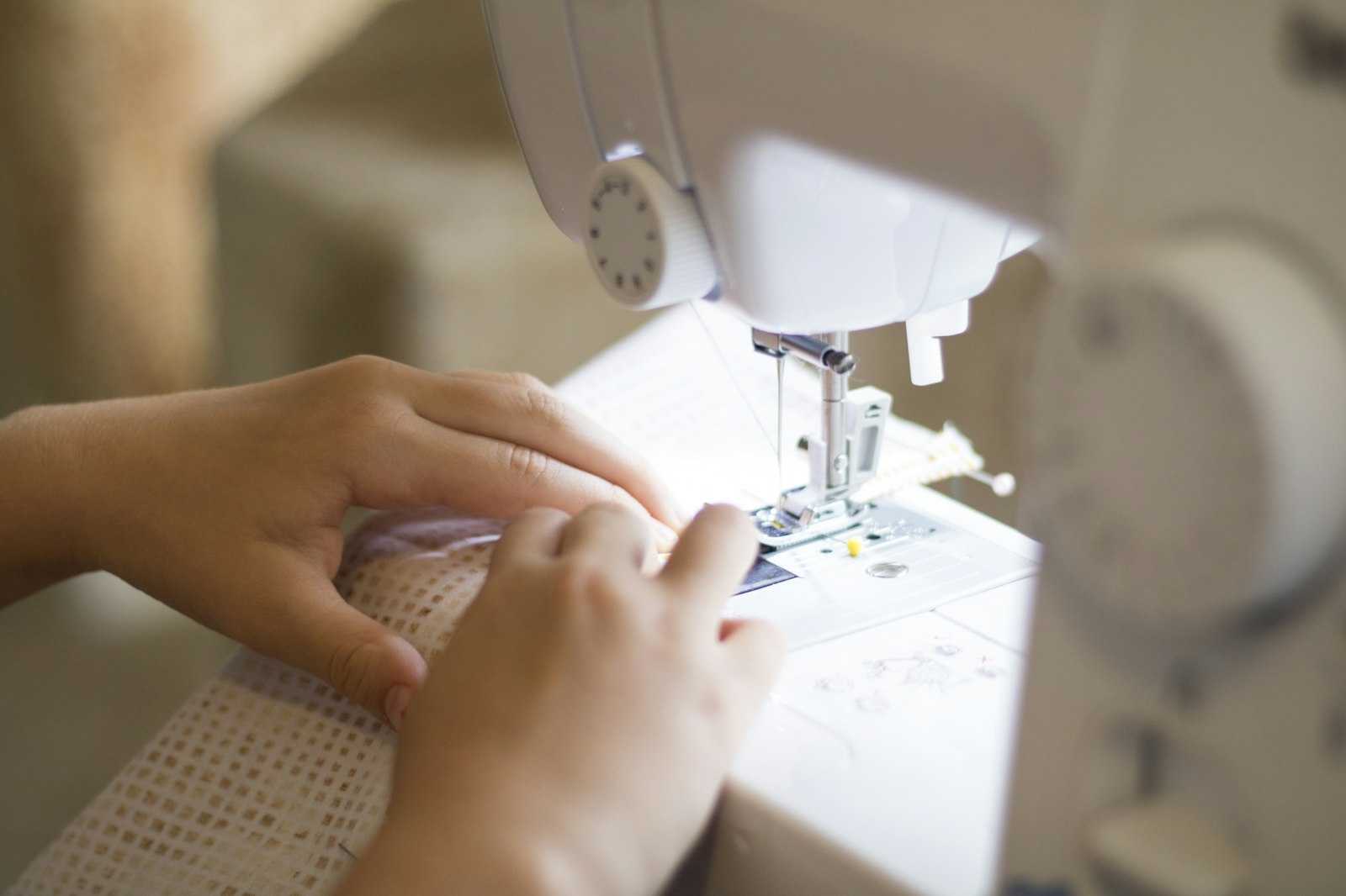 Detail of the hem and side seam stitching on a cotton t-shirt, showing an even double-needle stitch line