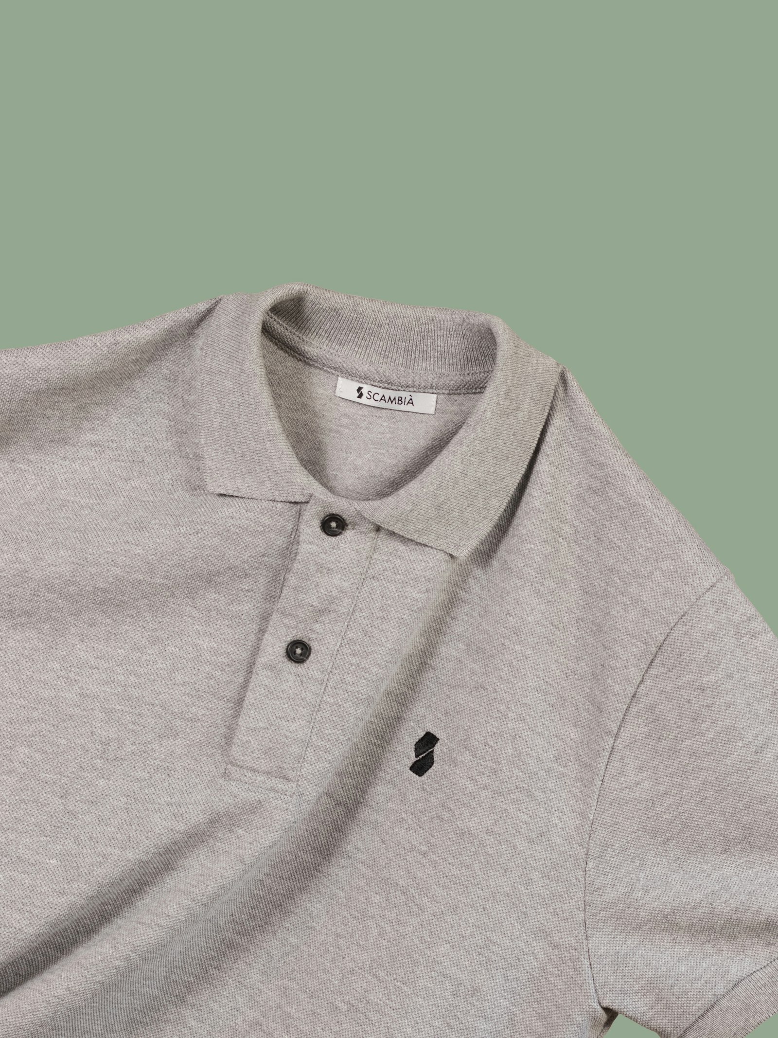 A close-up of an embroidered logo on a pique polo