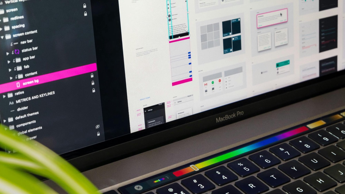 A logo file open in design software on a laptop