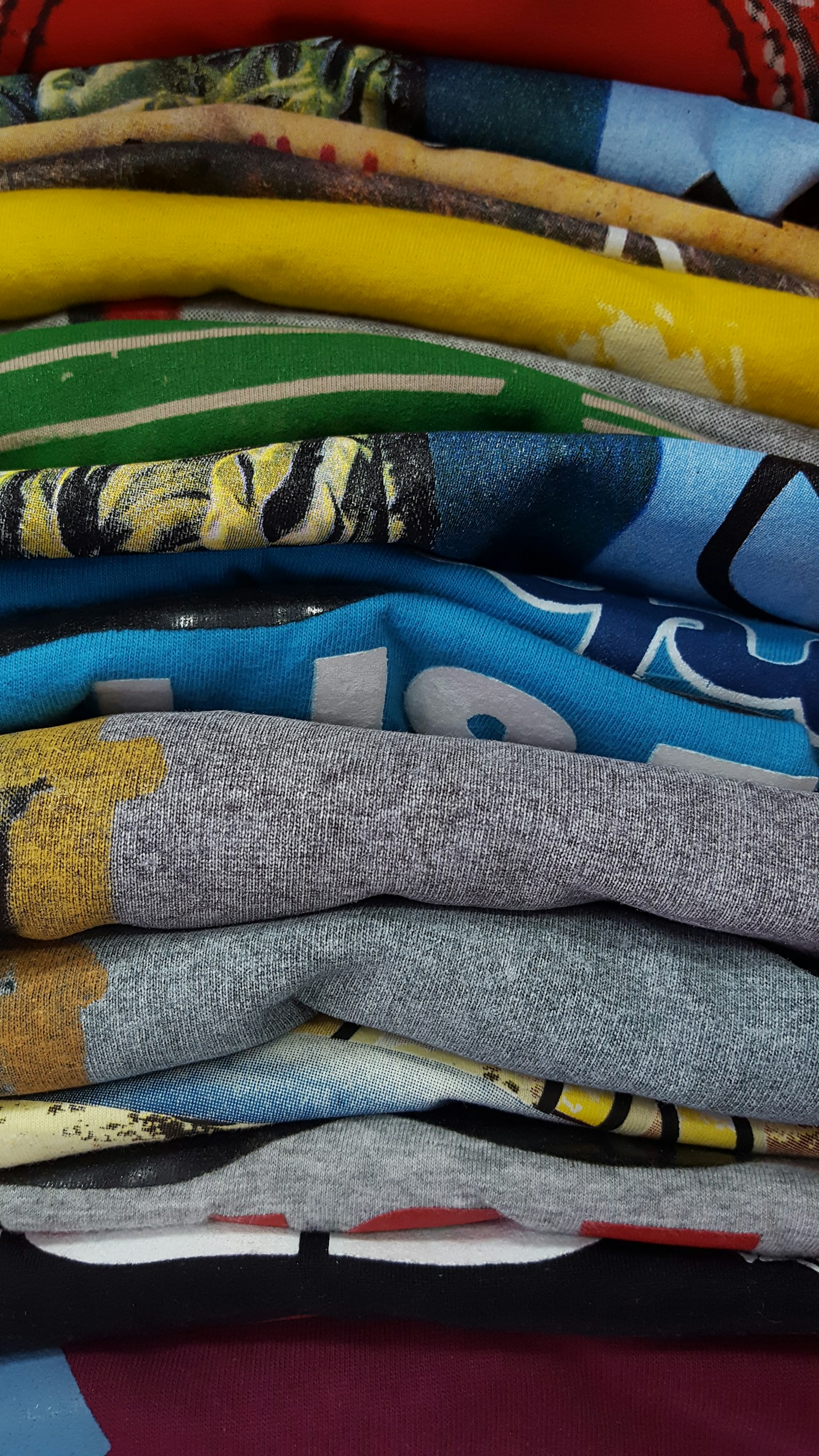 Finished printed t-shirts stacked after pressing