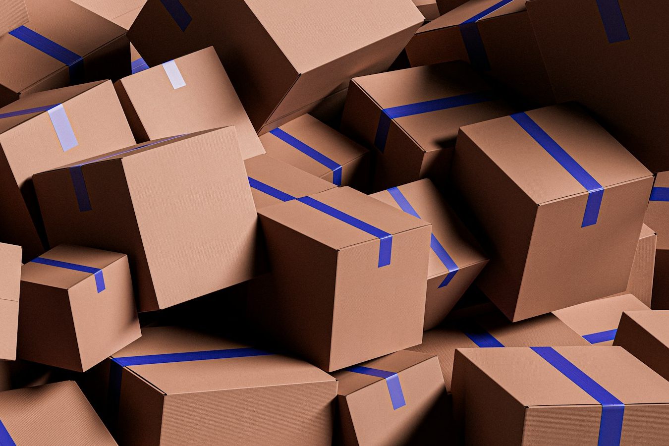 A heap of cardboard shipping boxes sealed with blue tape